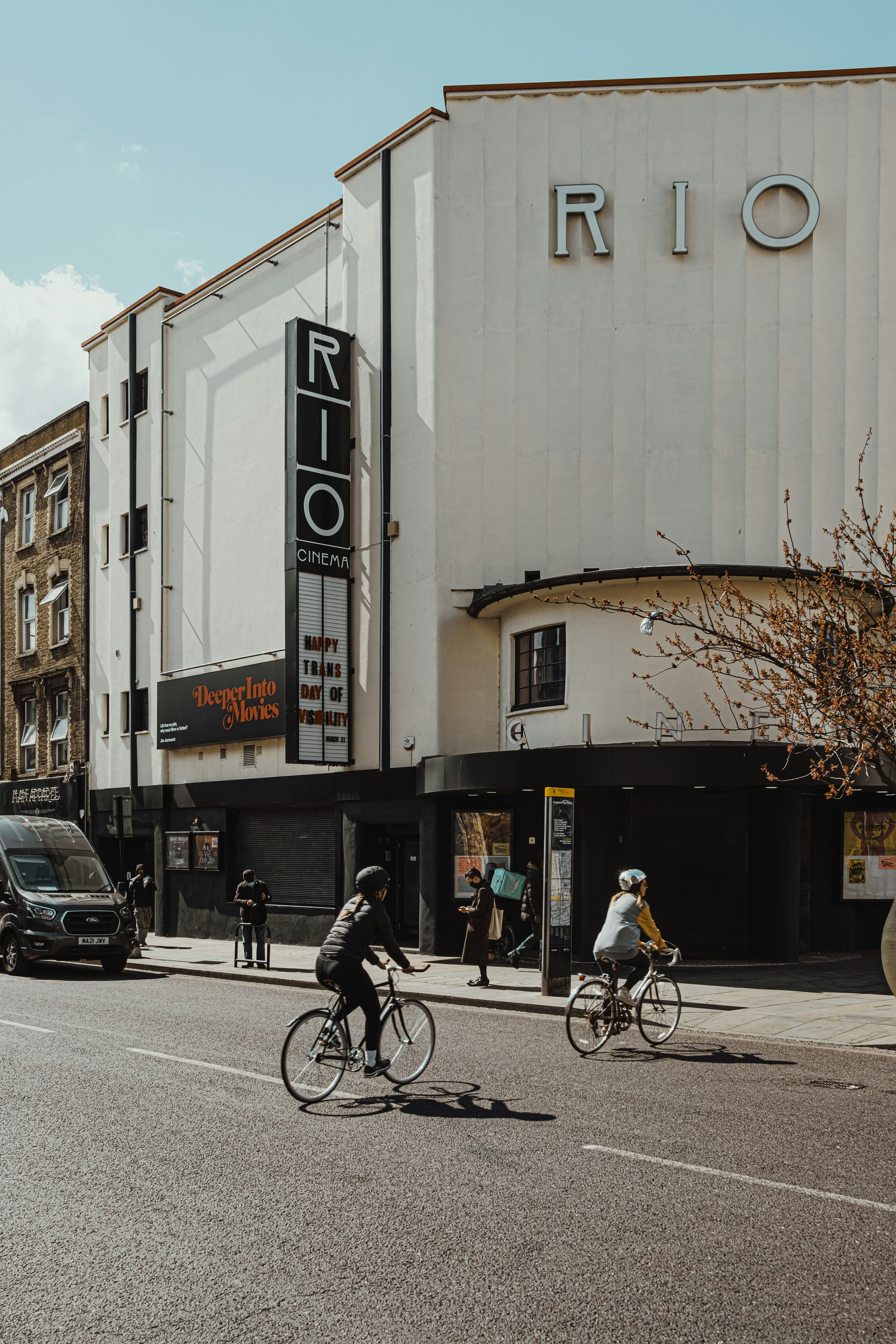 man in black jacket riding bicycle on road during daytime